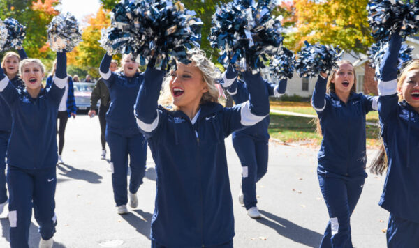Upper Iowa University cheerleaders march in a parade